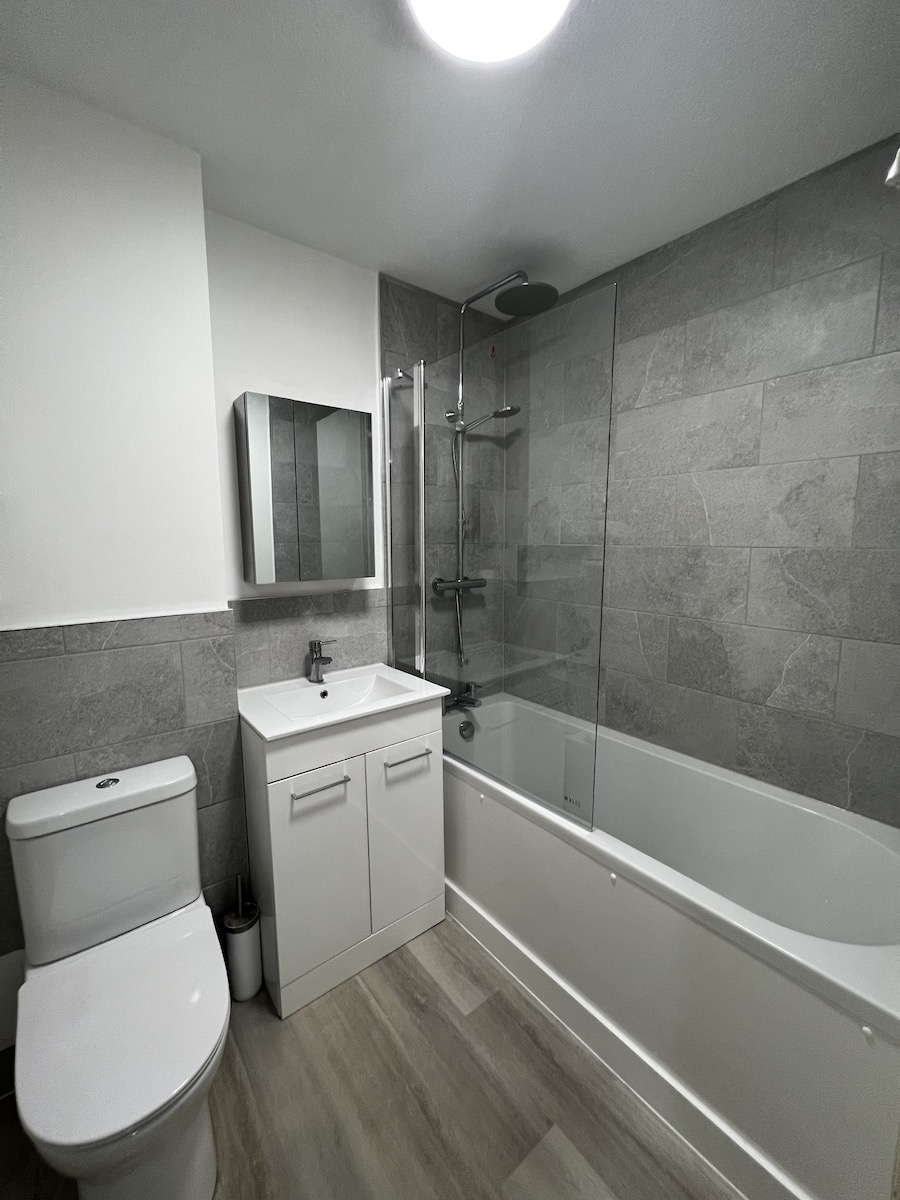 Grey bathroom with over-bath shower