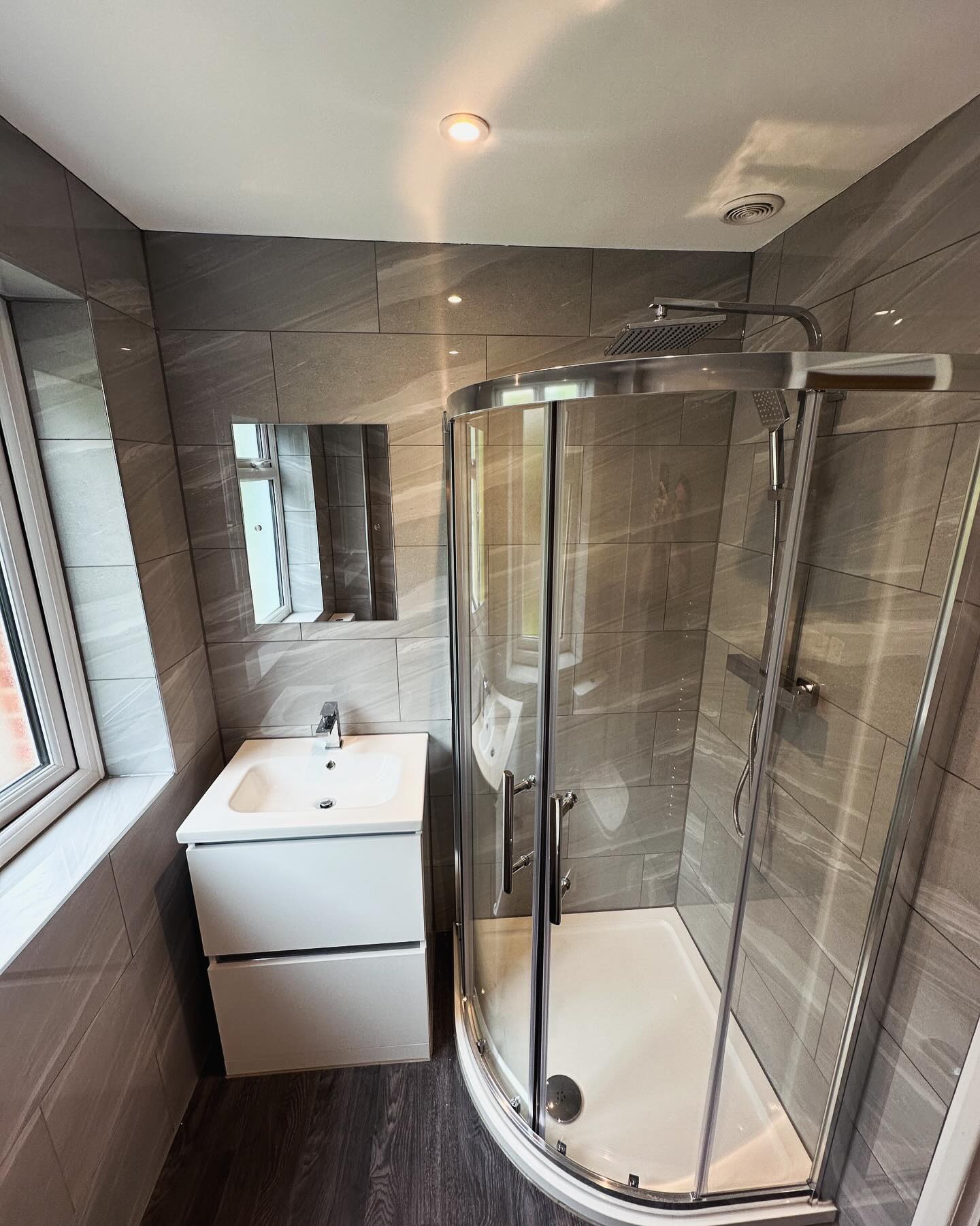 Modern grey bathroom with shower enclosure fitted by Zenith