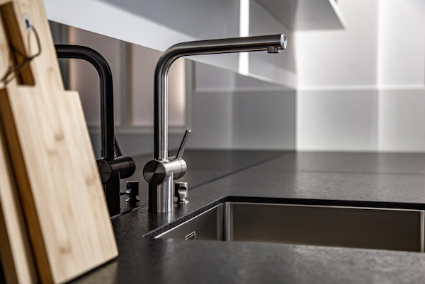 Zenith plumber repairing a leaking kitchen sink in Basingstoke